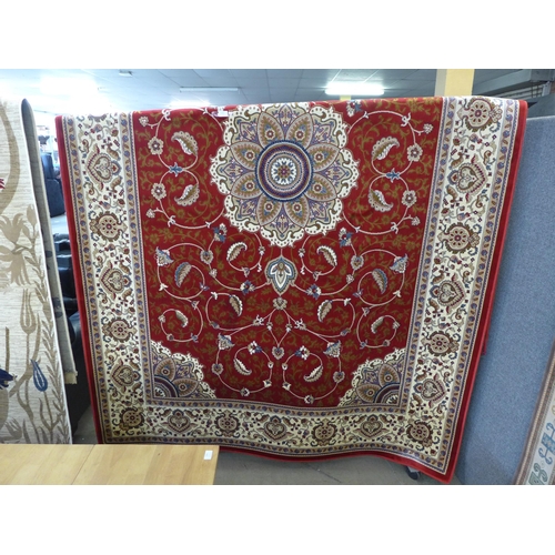 1520 - A red ground full pile Cashmere carpet, central floral medallion, 300 x 200cm