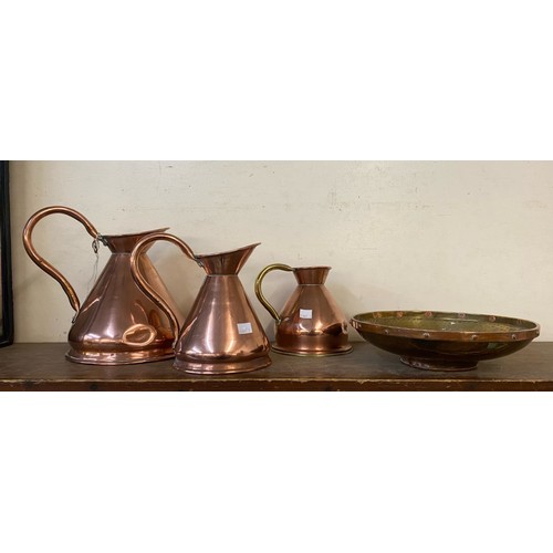 404 - Three graduated copper jugs and an Arts & Crafts bowl