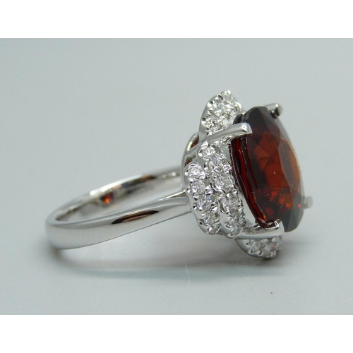 1064 - An 18ct white gold, spessartite garnet and diamond ring, garnet weight 9.03ct, diamond weight 0.47ct... 