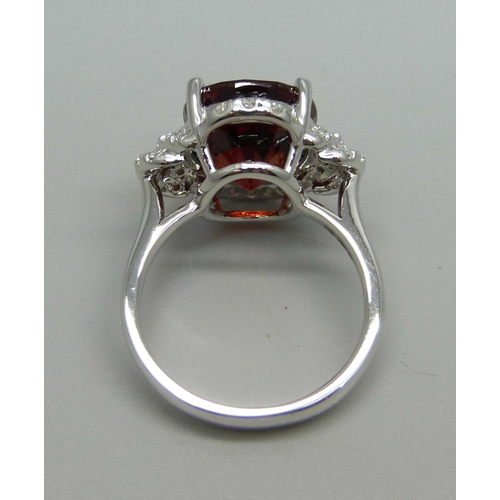 1064 - An 18ct white gold, spessartite garnet and diamond ring, garnet weight 9.03ct, diamond weight 0.47ct... 