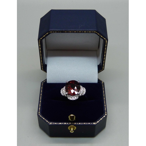 1064 - An 18ct white gold, spessartite garnet and diamond ring, garnet weight 9.03ct, diamond weight 0.47ct... 