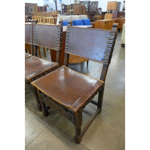 100 - A set of six 17th Century style oak and brown leather dining chairs