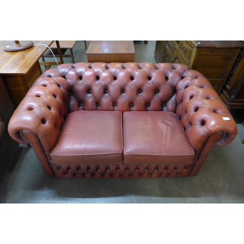 102 - A red leather Chesterfield settee