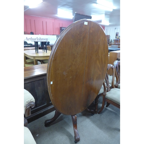 129 - A Victorian mahognay oval tilt top breakfast table and a set of four Victorian dining chairs