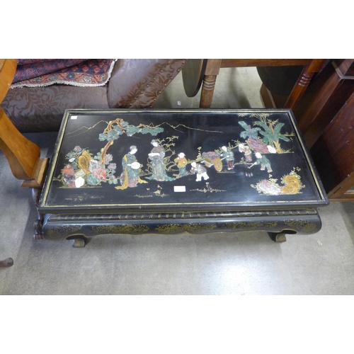 148 - A Chinese black lacquered chinoiserie coffee table (lacking glass top)