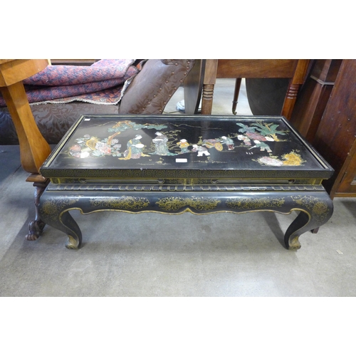 148 - A Chinese black lacquered chinoiserie coffee table (lacking glass top)