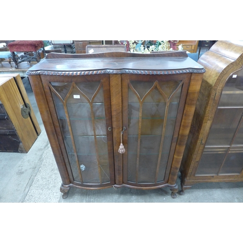 158 - A walnut serpentine two door display cabinet