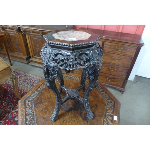 2 - A late 19th Century Chinese carved rosewood and marble topped octagonal jardinere stand