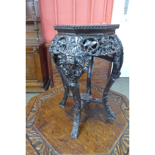 2 - A late 19th Century Chinese carved rosewood and marble topped octagonal jardinere stand