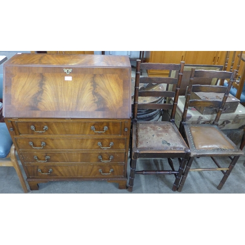 218 - A mahogany bureau and two oak chairs