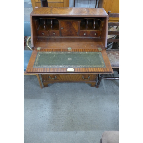 218 - A mahogany bureau and two oak chairs