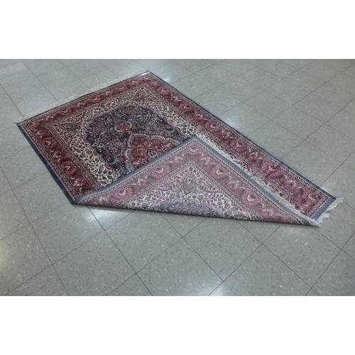 219 - A Chinese hand knotted silk salmon ground rug