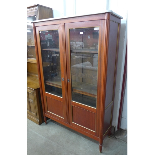 222 - A French Empire style mahogany and marble topped two door bookcase