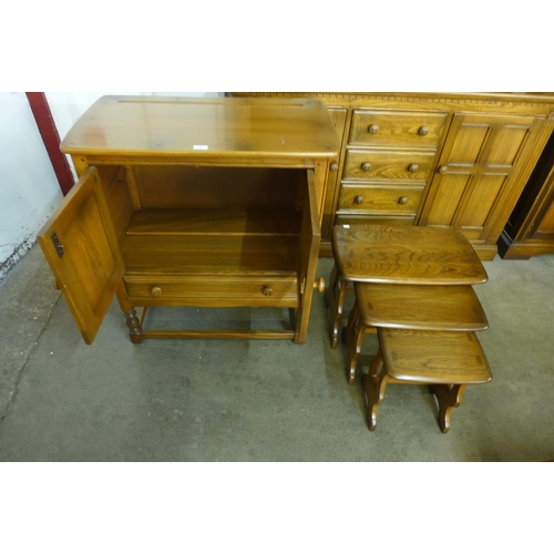 226 - An Ercol Golden Dawn elm cabinet and a nest of tables