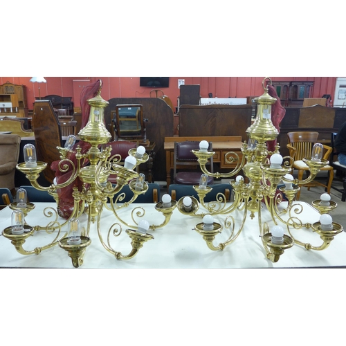 255 - A pair of Dutch style brass twelve branch chandeliers