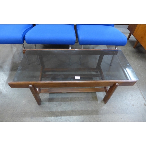 55 - A teak and glass topped rectangular coffee table