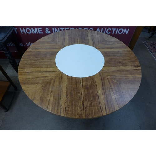 57B - A Merrow Associates rosewood and chrome circular dining table, with white laminate lazy Susan to cen... 