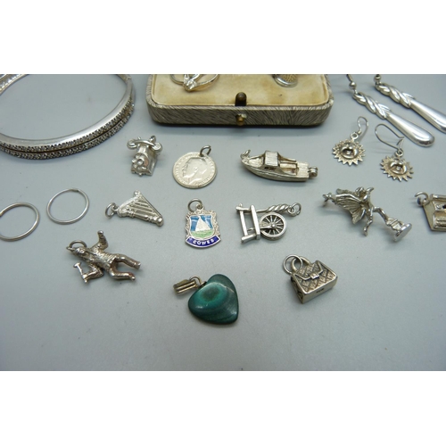 1003 - Silver jewellery comprising thirteen silver charms including one enamelled, three pairs of silver ea... 