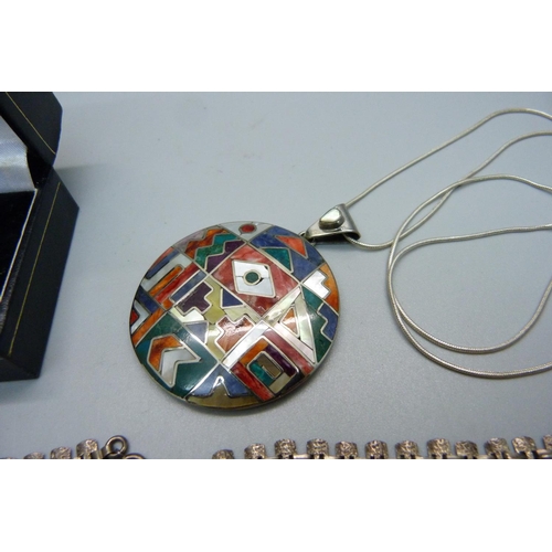 1008 - A silver and abalone shell ring, a silver fringe necklace and a silver Aztec pendant and chain