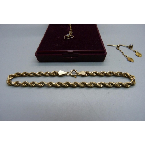 1050 - A 9ct gold bracelet, a pair of 9ct gold earrings and a 9ct gold necklace and pendant, total weight 3... 