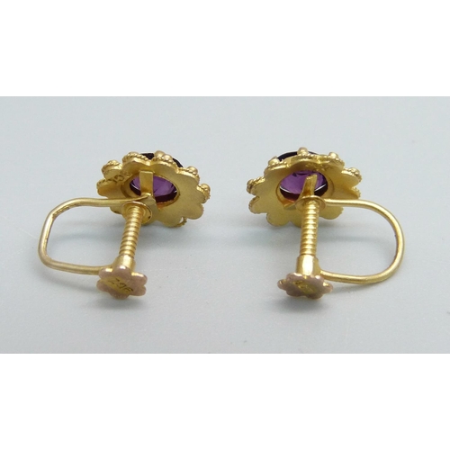 1058 - A pair of c1900 9ct gold and amethyst screw back earrings, 1.4g