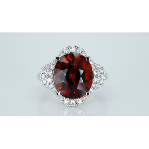 1064 - An 18ct white gold, spessartite garnet and diamond ring, garnet weight 9.03ct, diamond weight 0.47ct... 