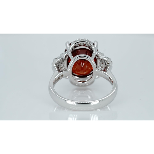 1064 - An 18ct white gold, spessartite garnet and diamond ring, garnet weight 9.03ct, diamond weight 0.47ct... 