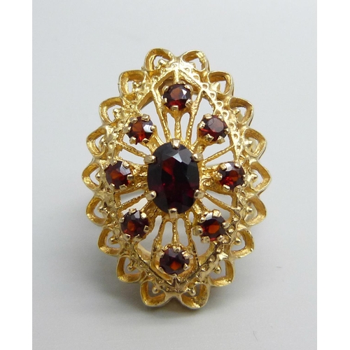 1066 - A 9ct gold and garnet ring, 6.3g, M