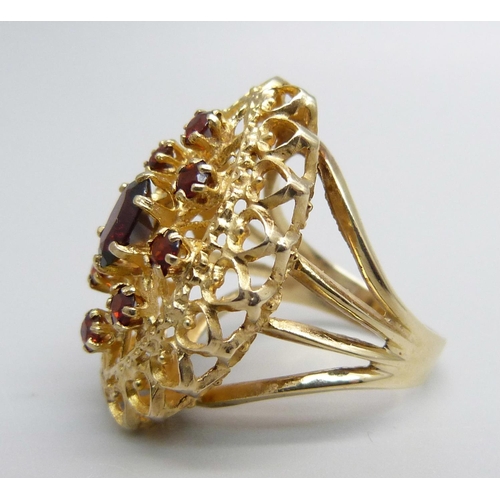 1066 - A 9ct gold and garnet ring, 6.3g, M