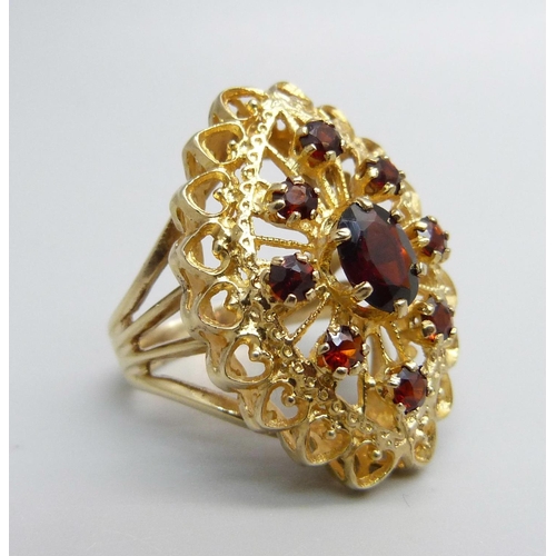 1066 - A 9ct gold and garnet ring, 6.3g, M