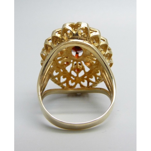 1066 - A 9ct gold and garnet ring, 6.3g, M