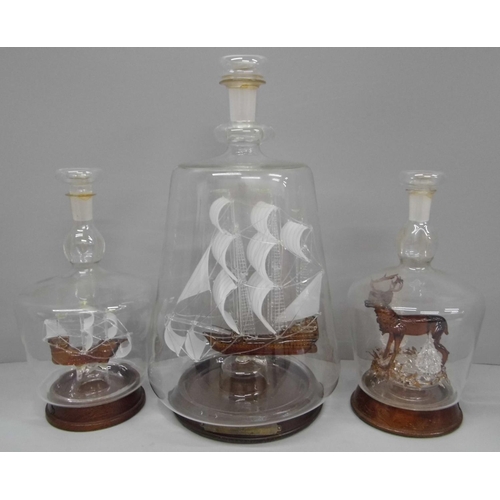 601 - Two glass models of ships in bottles and a glass model of a stag in a bottle