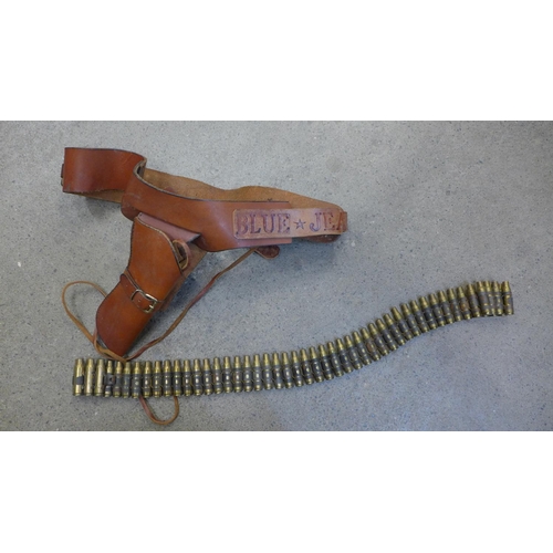 732 - A leather gun belt and holster with empty cartridges