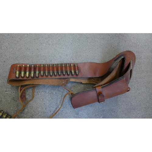 732 - A leather gun belt and holster with empty cartridges