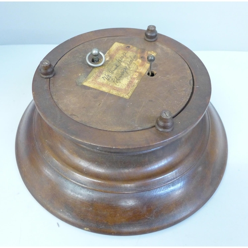 799 - A Black Forest carved musical bowl and a pair of brass and wooden handled nut crackers