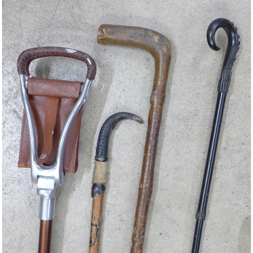 844 - Two walking canes, an umbrella frame and a shooting stick