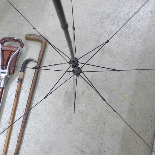 844 - Two walking canes, an umbrella frame and a shooting stick