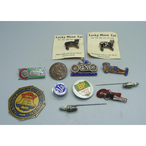 932 - An Isle of Man TT enamelled badge, two spark plug pins, pin badges, a badge by Miller of Birmingham,... 