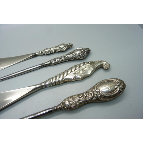 940 - Four silver handled tools; two button hooks and two shoe horns