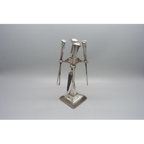 941 - A silver Art Deco manicure stand, Birmingham 1935, with four tools