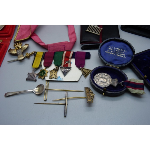 944 - A silver and enamel jewel, other lodge medallions and three silver spoons, weight of silver 71g