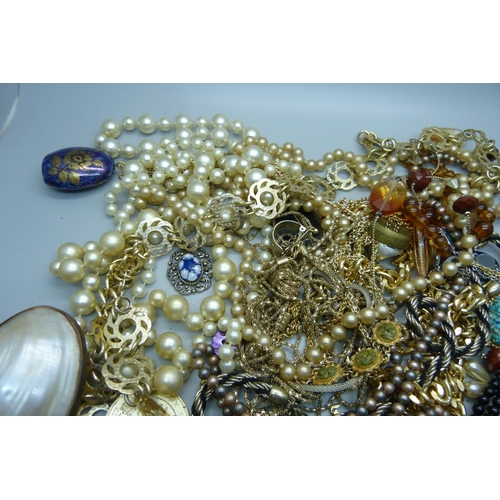 949 - A collection of costume jewellery and a mother of pearl purse