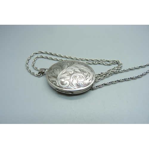 970 - A large silver engraved locket on chain