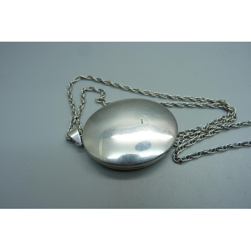 970 - A large silver engraved locket on chain