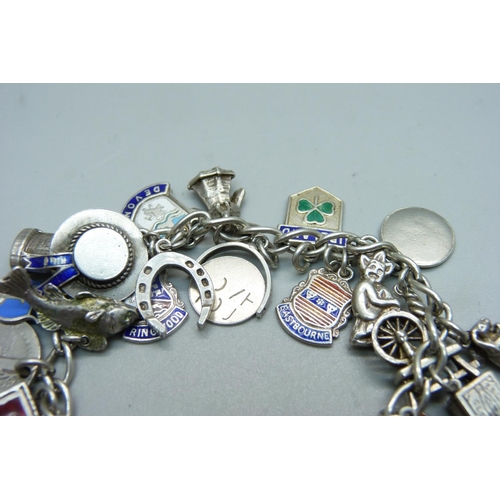 989 - A silver charm bracelet, including an 830 silver skis charm marked Norge, 55g