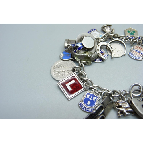 989 - A silver charm bracelet, including an 830 silver skis charm marked Norge, 55g