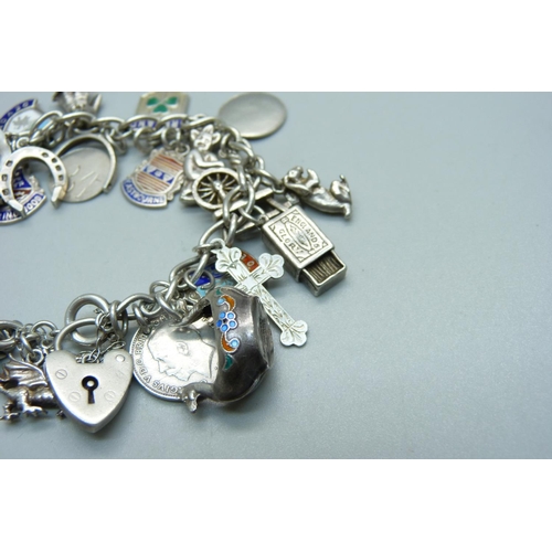 989 - A silver charm bracelet, including an 830 silver skis charm marked Norge, 55g