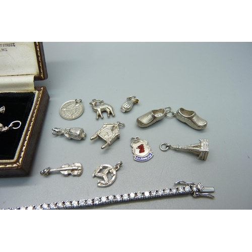 993 - Thirteen silver charms including one enamelled and a costume ring and tennis bracelet