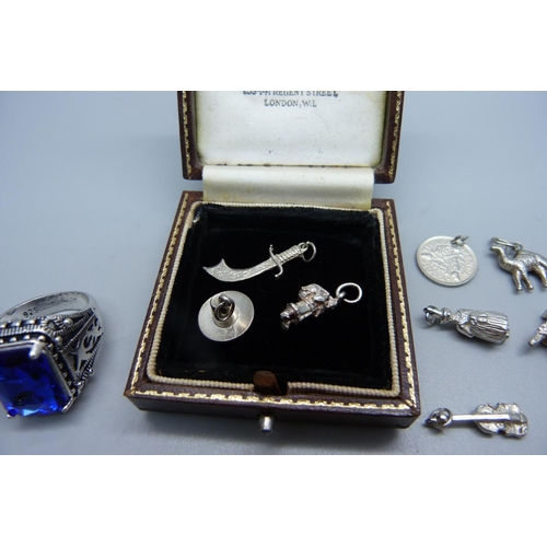 993 - Thirteen silver charms including one enamelled and a costume ring and tennis bracelet