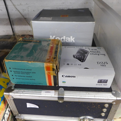 2251 - A camera box with a box of camera accessories including rolls of 35mm film, flash guns, booklets and... 